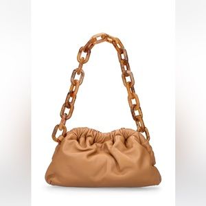 Mansur Gavriel mini cloud clutch in caramel with tortoise chain-link handle.